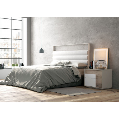 Ambiente de dormitorio con un cabecero en metal lacado mate y reposacabezas de polipiel